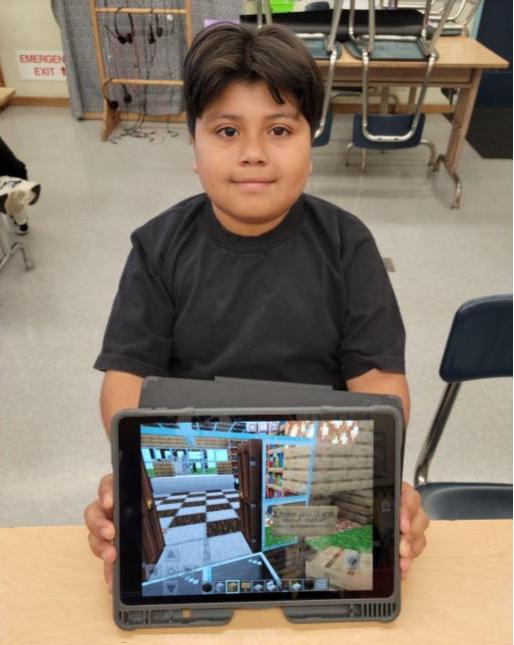 Brandon Guzman, 4th Grade student, showing his Minecraft:EE world.